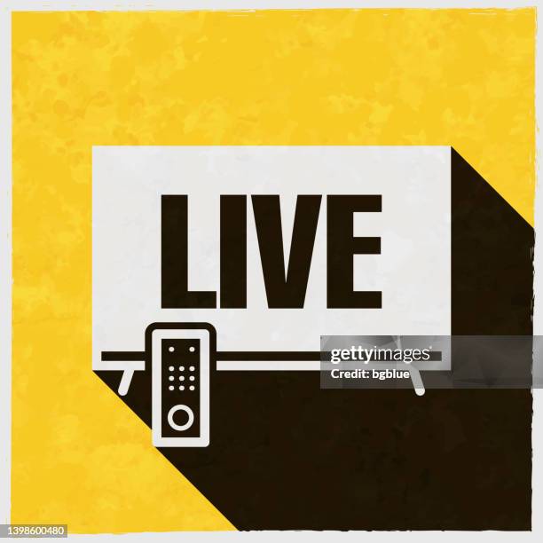 live on tv. icon with long shadow on textured yellow background - breaking news stock illustrations