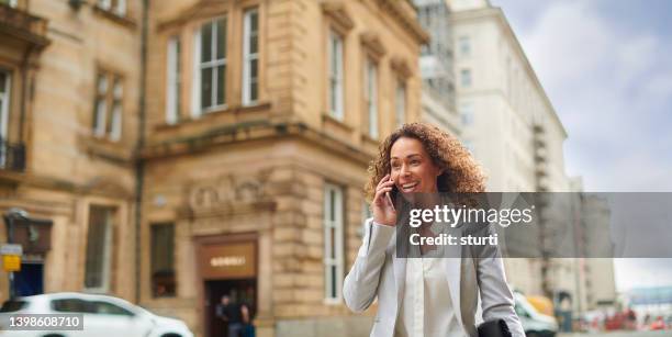 businesswoman connected - phone interview event stock pictures, royalty-free photos & images