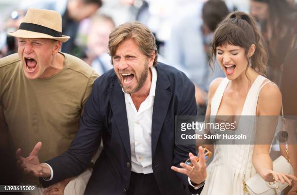 Woody Harrelson, Ruben Ostlund and Charlbi Dean Kriek attend the photocall for "Triangle Of Sadness" during the 75th annual Cannes film festival at...
