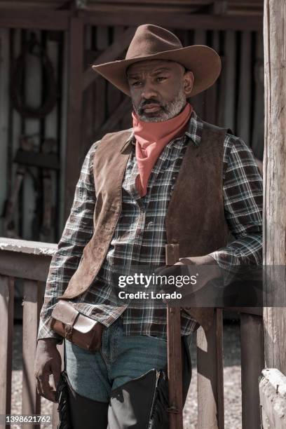 handsome black cowboy in an authentic wild west setting - period costume stock pictures, royalty-free photos & images