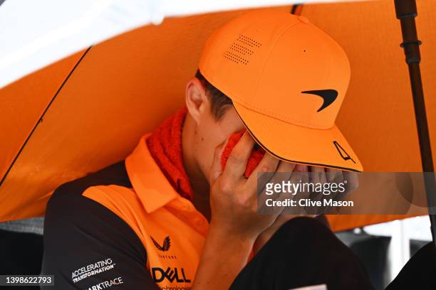Lando Norris of Great Britain and McLaren reacts to the heat on the drivers parade with a cool pack on his face prior to the F1 Grand Prix of Spain...
