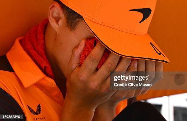 Lando Norris of Great Britain and McLaren reacts to the heat on the drivers parade with a cool pack on his face prior to the F1 Grand Prix of Spain...