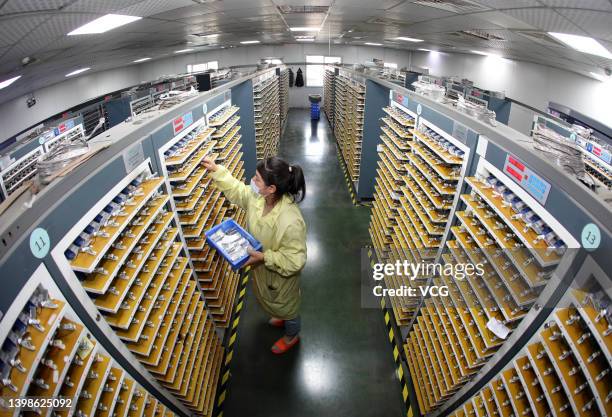 An employee works on the production line of lithium battery at the workshop of a new energy technology company on May 21, 2022 in Huaibei, Anhui...