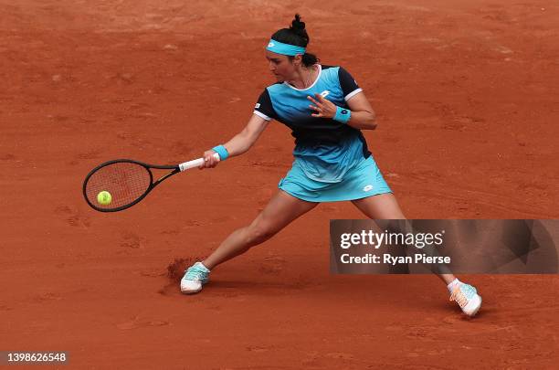 Ons Jabeur of Tunisia plays a forehand against against Magda Linette of Poland during the Women's Singles First Round match on Day 1 of The 2022...