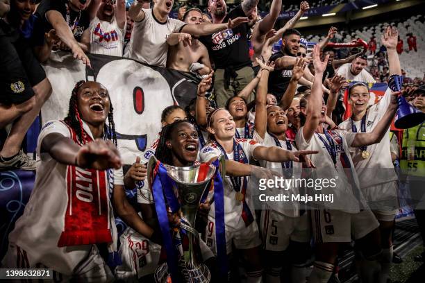 Griedge Mbock Bathy of Olympique Lyonnais and players celebrate with the UEFA Women's Champions League trophy following victory in the UEFA Women's...