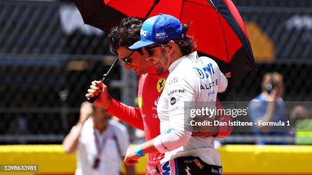 Carlos Sainz of Spain and Ferrari and Fernando Alonso of Spain and Alpine F1 hug on the grid during the F1 Grand Prix of Spain at Circuit de...