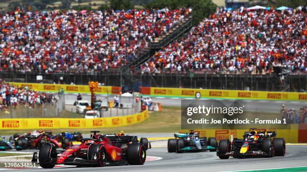 Charles Leclerc of Monaco driving the Ferrari F1-75 leads Max Verstappen of the Netherlands driving the Oracle Red Bull Racing RB18 at the start...