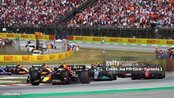 Sergio Perez of Mexico driving the Oracle Red Bull Racing RB18 leads Lewis Hamilton of Great Britain driving the Mercedes AMG Petronas F1 Team W13...