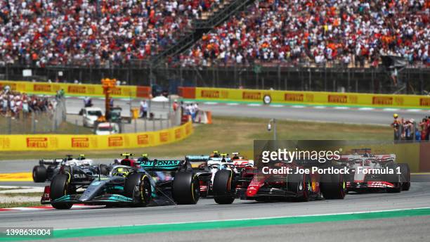 Lewis Hamilton of Great Britain driving the Mercedes AMG Petronas F1 Team W13 leads Carlos Sainz of Spain driving the Ferrari F1-75 during the F1...