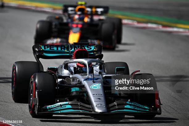 George Russell of Great Britain driving the Mercedes AMG Petronas F1 Team W13 leads Sergio Perez of Mexico driving the Oracle Red Bull Racing RB18...