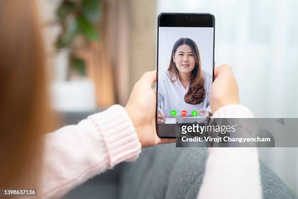 woman talking to her doctor on video call, online consultations via telemedicine technology. - doctor house call stock pictures, royalty-free photos & images