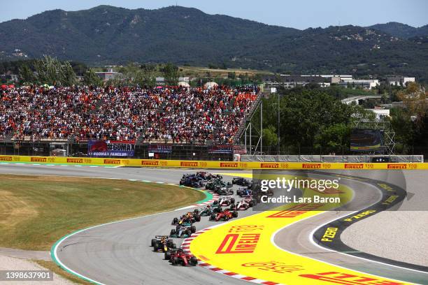 Charles Leclerc of Monaco driving the Ferrari F1-75 leads Max Verstappen of the Netherlands driving the Oracle Red Bull Racing RB18 and the rest of...