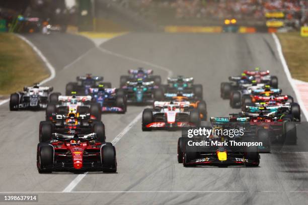 Charles Leclerc of Monaco driving the Ferrari F1-75 leads Max Verstappen of the Netherlands driving the Oracle Red Bull Racing RB18 and the rest of...