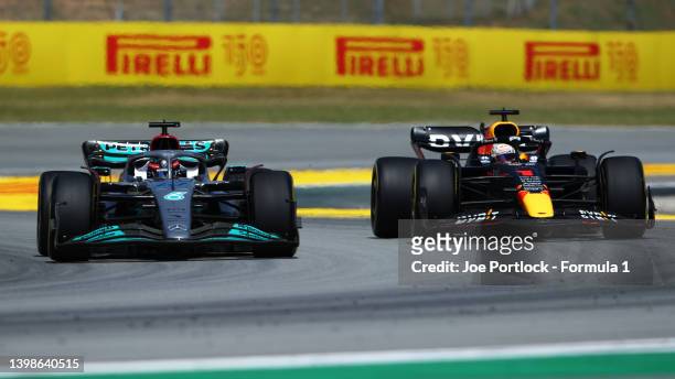 George Russell of Great Britain driving the Mercedes AMG Petronas F1 Team W13 and Max Verstappen of the Netherlands driving the Oracle Red Bull...