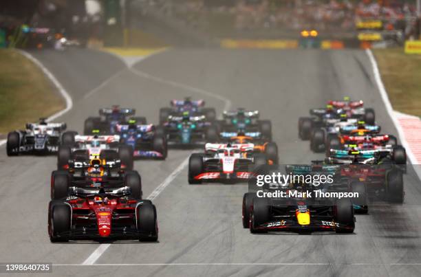 Charles Leclerc of Monaco driving the Ferrari F1-75 leads Max Verstappen of the Netherlands driving the Oracle Red Bull Racing RB18 and the rest of...