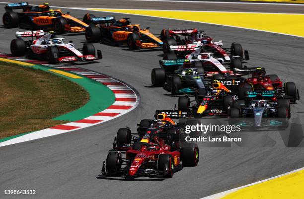 Charles Leclerc of Monaco driving the Ferrari F1-75 leads Max Verstappen of the Netherlands driving the Oracle Red Bull Racing RB18 and the rest of...