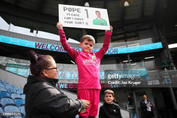 Young Burnley fan raises a message for Nick Pope of Burnley prior to the Premier League match between Burnley and Newcastle United at Turf Moor on...