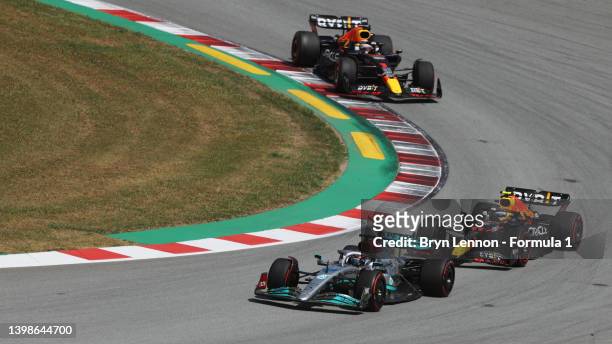 George Russell of Great Britain driving the Mercedes AMG Petronas F1 Team W13 leads Sergio Perez of Mexico driving the Oracle Red Bull Racing RB18...