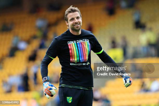 Tim Krul of Norwich City warms up wearing a shirt in support of Blackpool footballer, Jake Daniels prior to the Premier League match between Norwich...