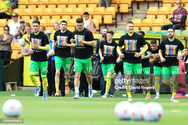 Norwich City players warm up wearing shirts in support of Blackpool footballer, Jake Daniels prior to the Premier League match between Norwich City...