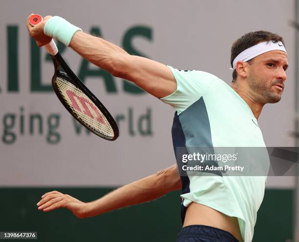 Grigor Dimitrov of Bulgaria plays a backhand during his mens singles first round against Marcos Giron of the United States on day 1 of the 2022...