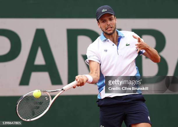 Gregoire Barrere of France plays a forehand against Taro Daniel of Japan in their mens singles first round match during the 2022 French Open at...