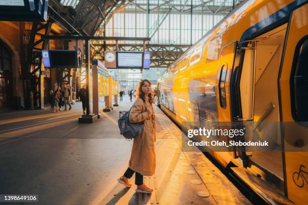 woman waiting for the train on railway station - pendlare bildbanksfoton och bilder