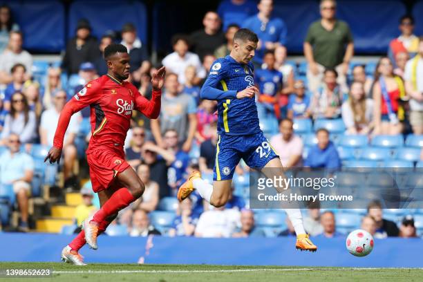 Kai Havertz of Chelsea runs with the ball whilst under pressure from Christian Kabasele of Watford FC during the Premier League match between Chelsea...