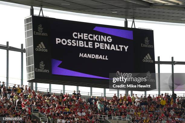 The LED board shows VAR checking a possible penalty for handball which is later given to Arsenal during the Premier League match between Arsenal and...