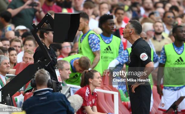 Referee Andre Marriner checks the VAR screen for a possible penalty which is later given to Arsenal for handball during the Premier League match...