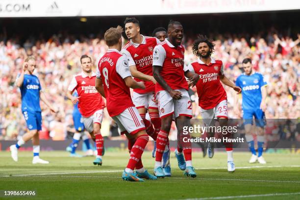 Gabriel Martinelli celebrates with teammates Martin Oedegaard and Nuno Tavares of Arsenal after scoring their team's first goal from the penalty spot...