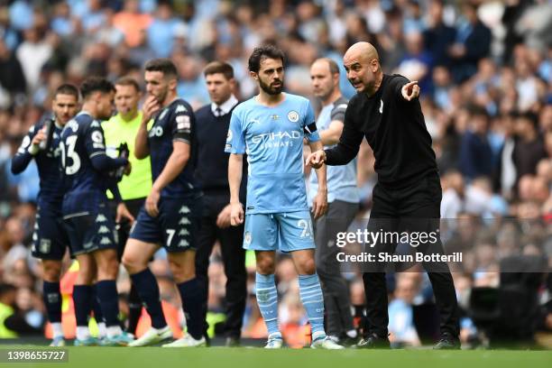 Pep Guardiola, Manager of Manchester City gives their team instructions during the Premier League match between Manchester City and Aston Villa at...