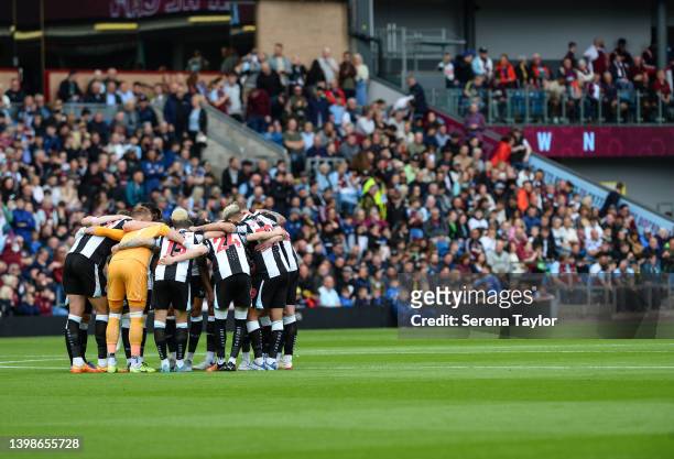 The Newcastle team huddle during the Premier League match between Burnley and Newcastle United at Turf Moor on May 22, 2022 in Burnley, England.