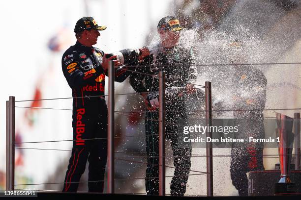 Race winner Max Verstappen of the Netherlands and Oracle Red Bull Racing and Third placed George Russell of Great Britain and Mercedes celebrate on...