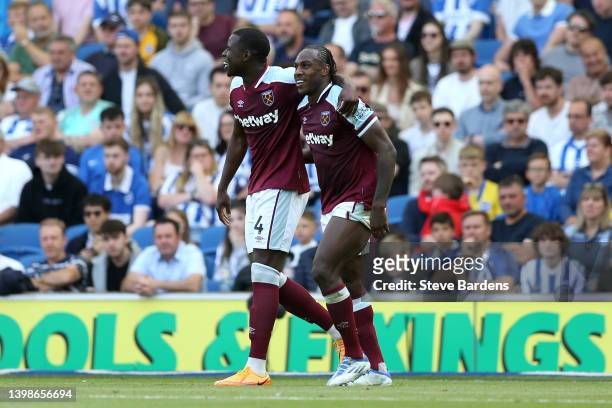 Michail Antonio of West Ham United celebrates with teammate Kurt Zouma after scoring their side's first goal during the Premier League match between...