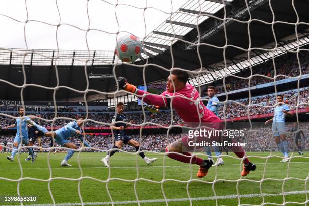 Matty Cash of Aston Villa scores their team's first goal past Ederson of Manchester City during the Premier League match between Manchester City and...
