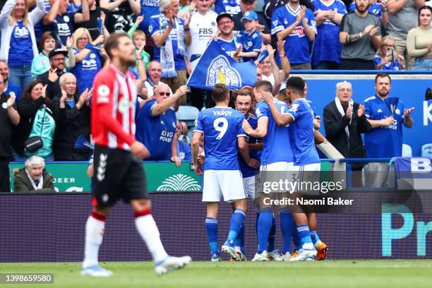 James Maddison of Leicester City celebrates with teammates after scoring their team's first goal during the Premier League match between Leicester...