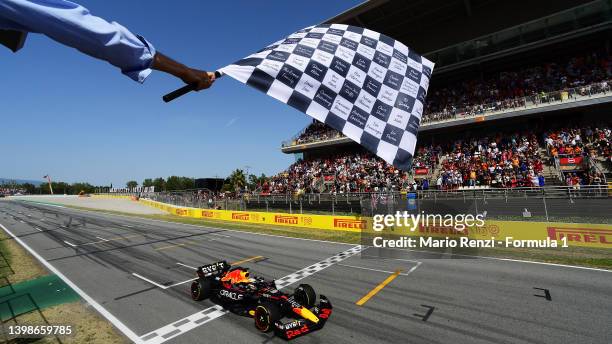 Race winner Max Verstappen of the Netherlands driving the Oracle Red Bull Racing RB18 takes the chequered flag during the F1 Grand Prix of Spain at...