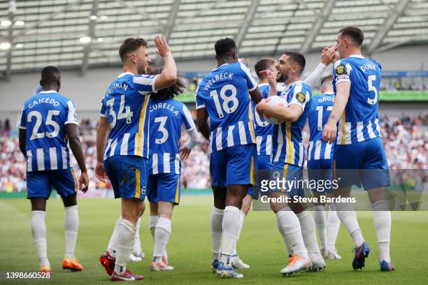 Joel Veltman of Brighton & Hove Albion celebrates with Neal Maupay and teammates after scoring their side's first goal during the Premier League...