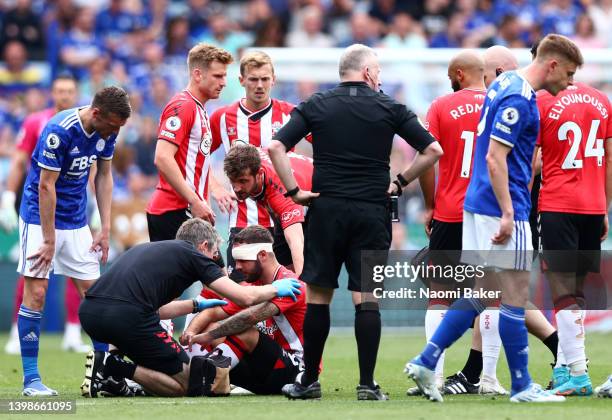 Adam Armstrong of Southampton receives medical treatment before going off with an injury during the Premier League match between Leicester City and...