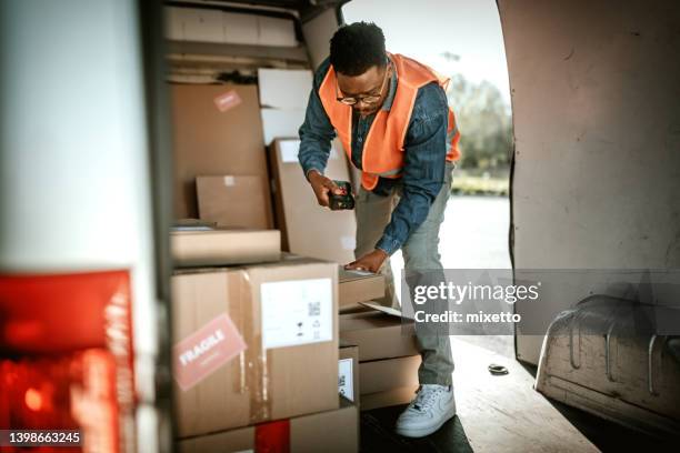 delivery worker scanning qr code on a box - delivery van stock pictures, royalty-free photos & images