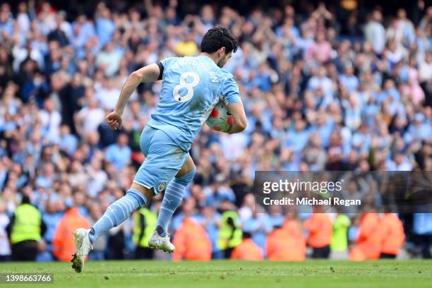 Ilkay Guendogan of Manchester City celebrates after scoring their team's first goal during the Premier League match between Manchester City and Aston...