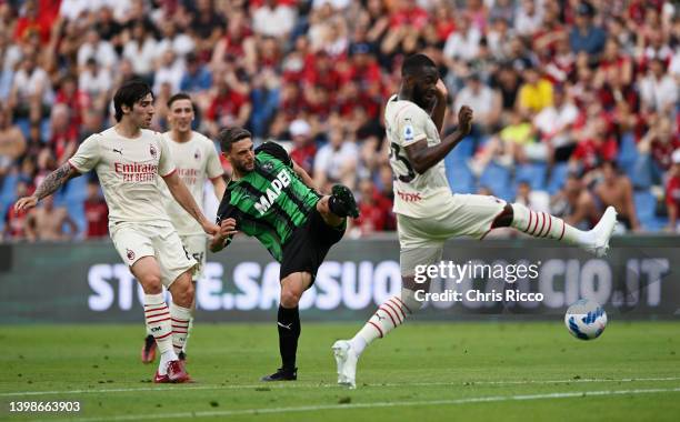 Domenico Berardi of US Sassuolo is challenged by Fikayo Tomori andSandro Tonali of AC Milan during the Serie A match between US Sassuolo and AC Milan...