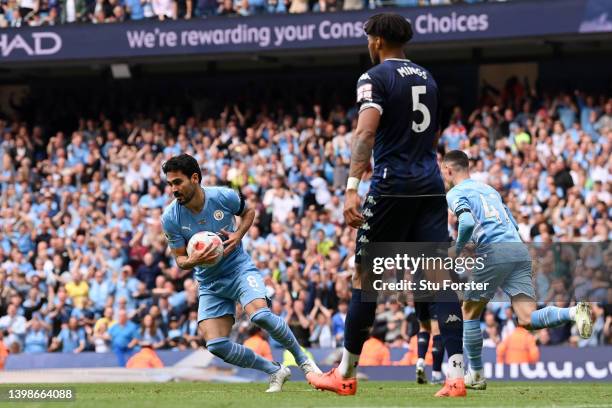 Ilkay Guendogan of Manchester City celebrates after scoring their team's first goal during the Premier League match between Manchester City and Aston...