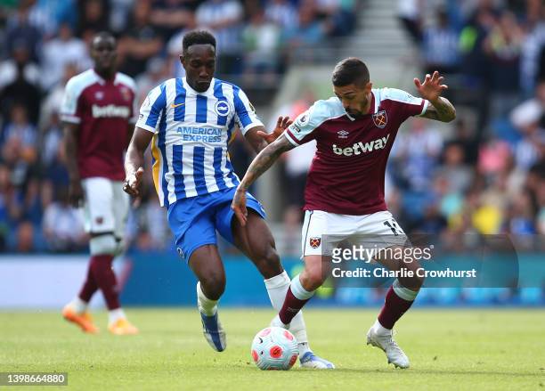 Danny Welbeck of Brighton & Hove Albion battles for possession with Manuel Lanzini of West Ham United during the Premier League match between...