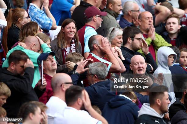 Burnley fans look dejected during the Premier League match between Burnley and Newcastle United at Turf Moor on May 22, 2022 in Burnley, England.