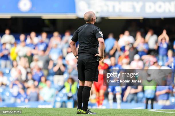 Referee Mike Dean, officiating his last game, after the Premier League match between Chelsea and Watford at Stamford Bridge on May 22, 2022 in...