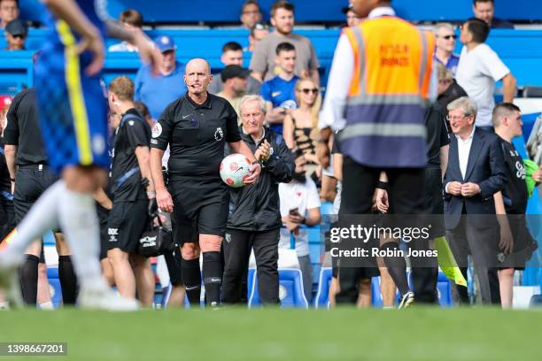 Referee Mike Dean, officiating his last game, after the Premier League match between Chelsea and Watford at Stamford Bridge on May 22, 2022 in...