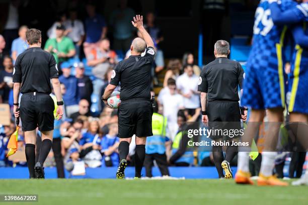 Referee Mike Dean, officiating his last game, after the Premier League match between Chelsea and Watford at Stamford Bridge on May 22, 2022 in...