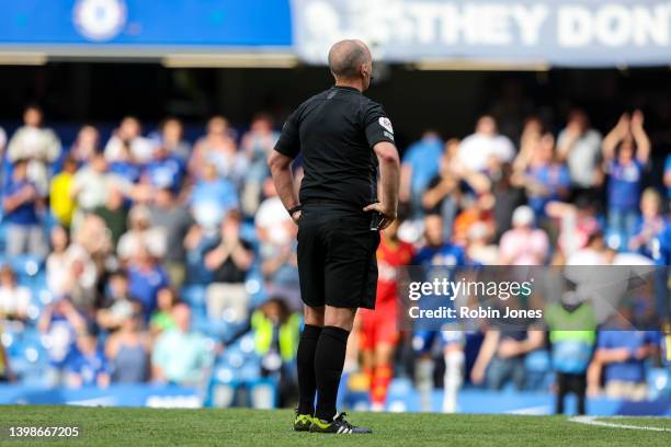 Referee Mike Dean, officiating his last game, after the Premier League match between Chelsea and Watford at Stamford Bridge on May 22, 2022 in...